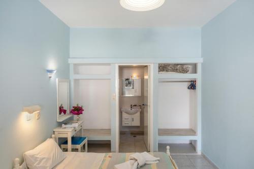 a small room with a table and a bathroom at Hotel Glaros Karpathos in Karpathos