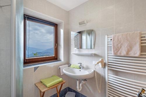 a white bathroom with a sink and a window at Galtinerhof in Rodengo