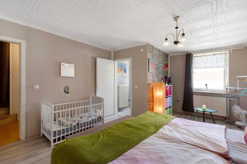 a bedroom with a crib and a room with a crib at Wohnung Im Hinterhof in Querfurt