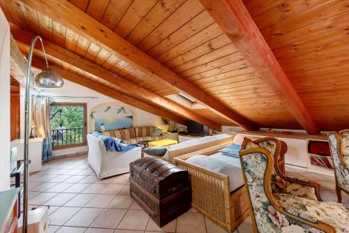 a large living room with a wooden ceiling at La Liguria tra gli Ulivi 2 in Varazze