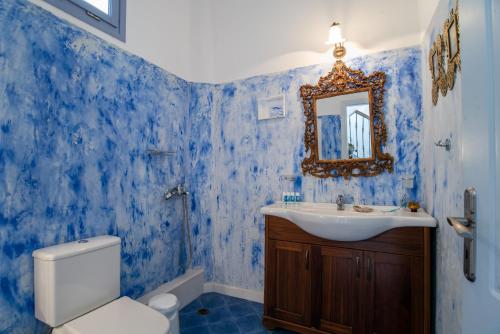 a blue bathroom with a sink and a toilet at Orkos View House in Naxos Chora
