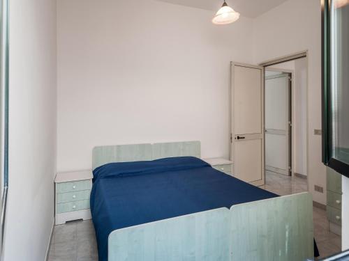 a bedroom with a blue bed and a mirror at Villa Tetta sul mare in Torre Lapillo