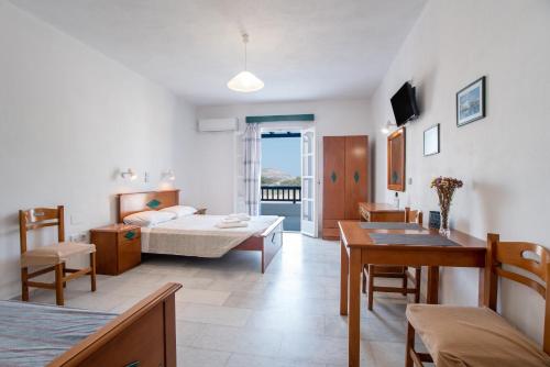 a living room with a bed and a table at Galanos Studios Naxos in Naxos Chora
