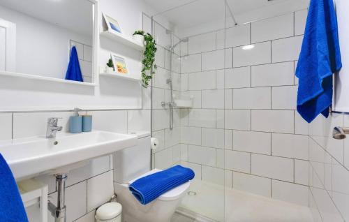 a white bathroom with a toilet and a sink at Oasis Duna_Sun Fun Pool in Corralejo