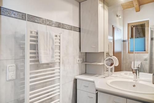 a white bathroom with a sink and a shower at Ferienwohnung Gallist in Oberammergau