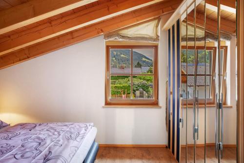 a bedroom with a bed and a window at Ferienwohnung Gallist in Oberammergau