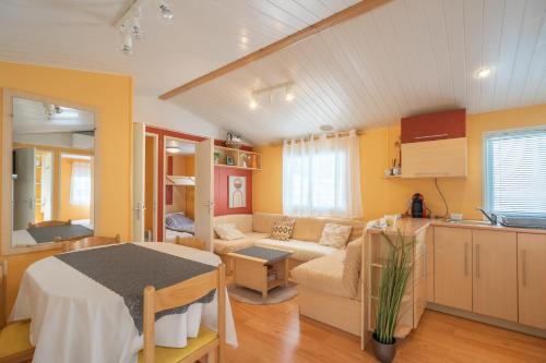 a living room with a couch and a table at Mh 61 La Tremblade in La Tremblade