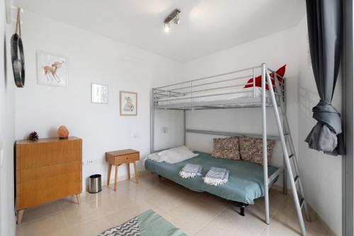 a bedroom with a bunk bed and a desk at Villa en Taro in Güimar