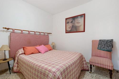 a bedroom with a bed and a picture on the wall at Casa Maria Cosme in Los Realejos