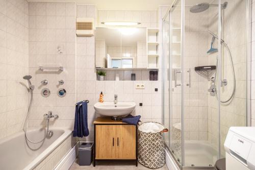 a bathroom with a sink and a shower at Tulips Apartment in Meckenbeuren
