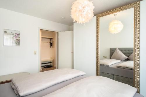 a mirror in a room with two beds at Tulips Apartment in Meckenbeuren