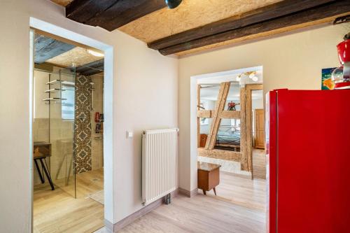 a room with a red refrigerator and a mirror at Schwarzwald Ruhe in Altensteig