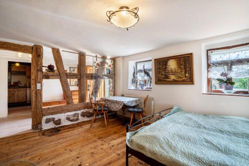 a bedroom with a bed and a desk in it at Schwarzwald Ruhe in Altensteig