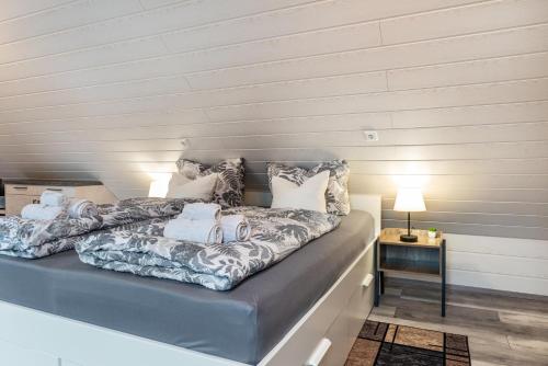 a bed with towels on it in a room at Opitz in Allensbach
