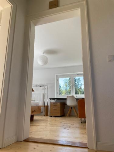 an open door to a room with a desk in a room at Hofberg Villa in Landshut