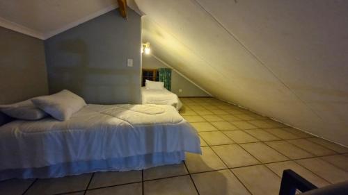 a bedroom with two beds in a attic at Pendleberry Unit 85 in Warmbaths
