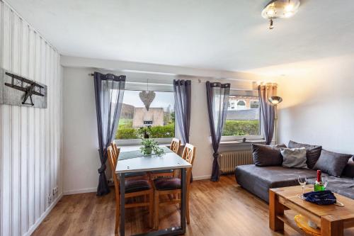 a living room with a table and a couch at Ferienwohnung Wilde Schanze in Hoppecke