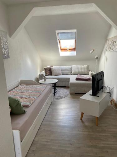 a living room with a bed and a couch at Mein kleines Reich in Zwickau