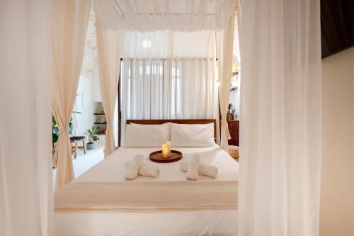 a bedroom with a bed with a candle on it at Archè Luxury private Spa in Polignano a Mare