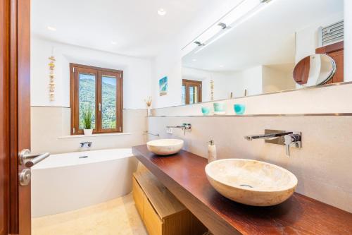 a bathroom with two sinks on a wooden counter at Sa Papaiona in Valldemossa