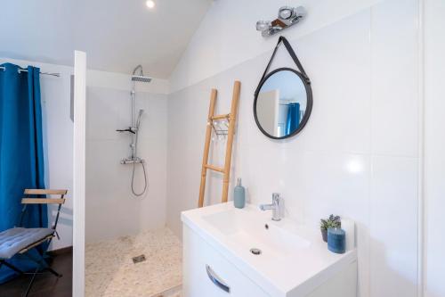 a bathroom with a sink and a mirror on the wall at Chambre Chene in Mauléon-dʼArmagnac