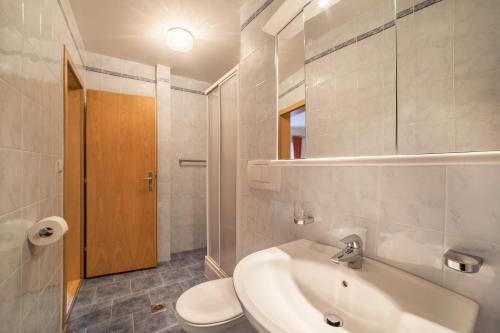 a bathroom with a white sink and a toilet at Residence Pichler Apartment 7 in San Leonardo in Passiria