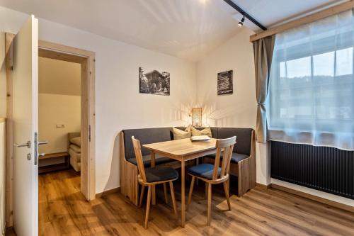 a dining room with a table and chairs at Bergwelt B in Niederau