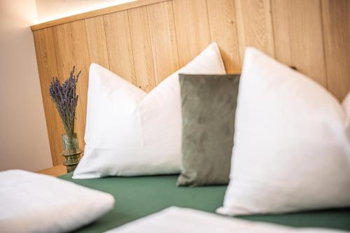 a group of pillows sitting on top of a bed at Zum Sonnentor App Larix 2 in Lutago