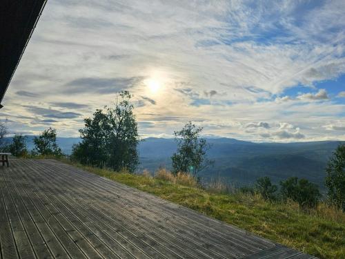 a view of a road with the sun in the sky at Mountain Cabin With Panoramic Views And Sauna in Oppdal