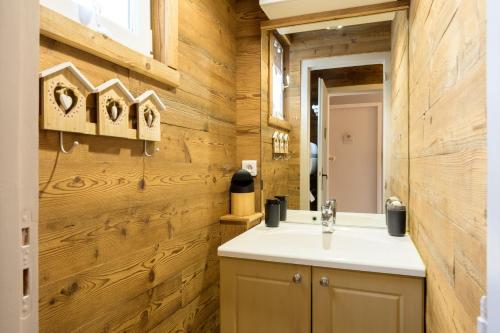 a bathroom with a sink and a mirror at La Petite Chaumière avec sauna in Saint-Maurice-sur-Moselle