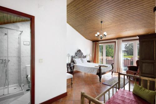 a large room with a bed and a bathroom at Casa de Barqueiros in Barqueiros