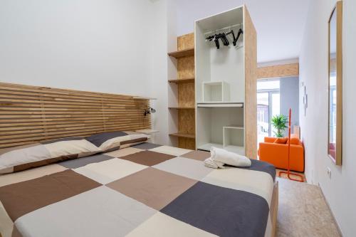 a bedroom with a large bed with a checkered floor at La Casa di Laura in Putignano