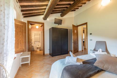 a bedroom with a large bed and a bathroom at Masseria del bosco Poderuccio in Chianciano Terme