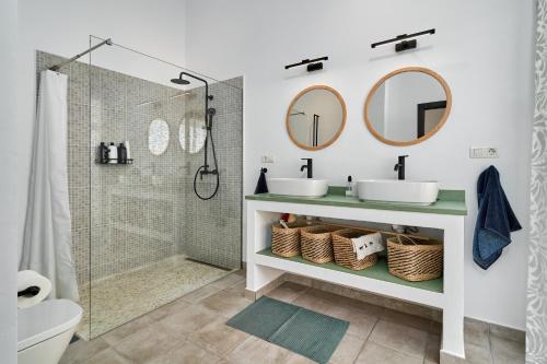 a bathroom with two sinks and a shower at El Cine in Canillas de Albaida