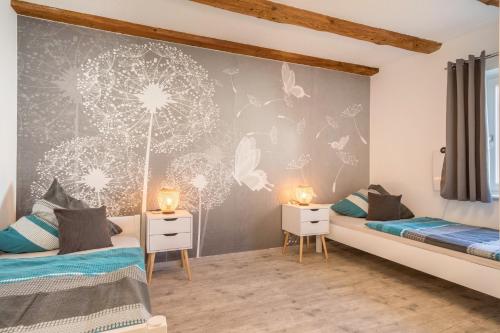 two beds in a room with butterflies on the wall at Ferienwohnung Relax in Sigmarszell