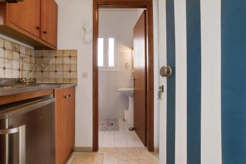 a small bathroom with a sink and a toilet at Areti Orfeas Studio in Vasilikos