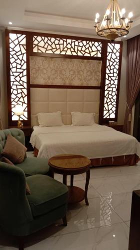 a bedroom with a bed and a table and chairs at فلل لوسيرن in Khamis Mushayt