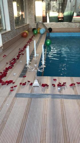 a swimming pool with candles and red bows on the floor at فلل لوسيرن in Khamis Mushayt
