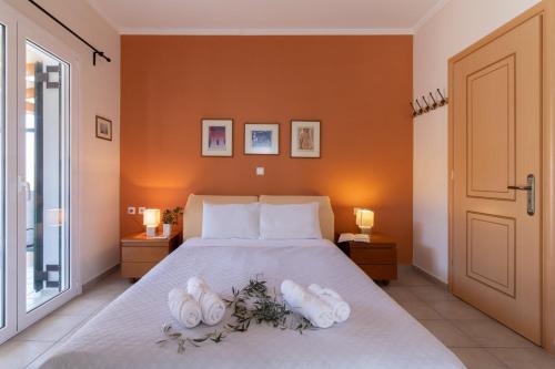 a bedroom with a bed with white towels on it at Villa Votistis A2 in Lefkada