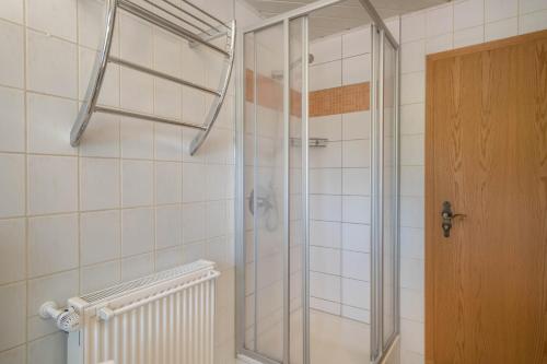 a shower with a glass door in a bathroom at Haus Schussenblick Og in Eriskirch