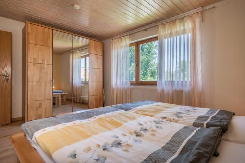 a bedroom with a bed and a large window at Haus Schussenblick Og in Eriskirch