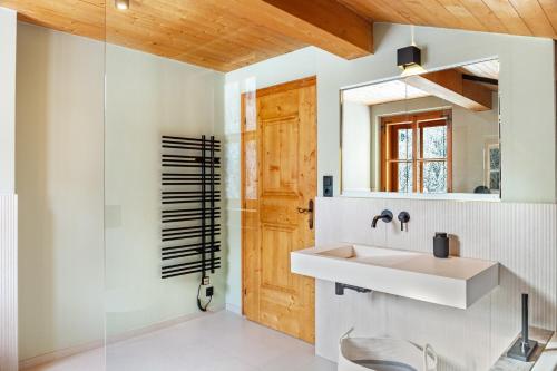 a bathroom with a sink and a mirror at Chalet Flocke Sternschnuppe in Sankt Anton am Arlberg