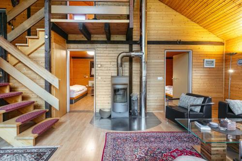 a living room with a fireplace in a house at Feriendorf Rechbergblick, Haus 29 in Bernau im Schwarzwald