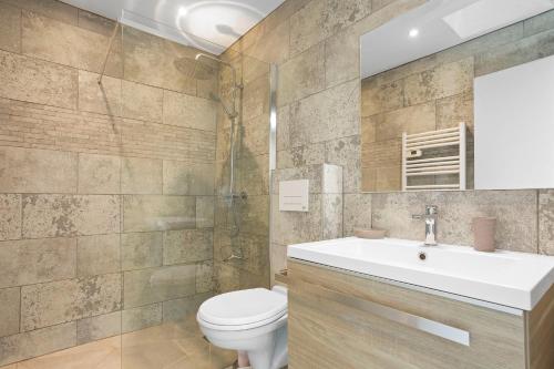 a bathroom with a white sink and a toilet at Maison Saint-Raphael - Les Vignes in Saint-Raphaël