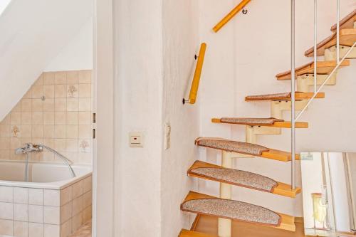 a staircase in a bathroom with a bath tub at Reichenaublick in Allensbach
