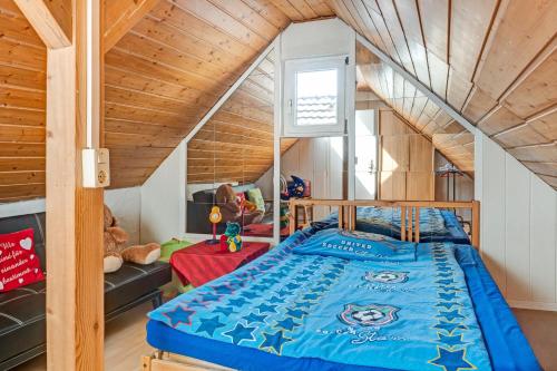 a bed in a room with a wooden ceiling at Reichenaublick in Allensbach