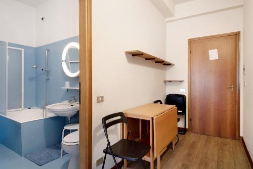 a bathroom with a sink and a toilet and a desk at Appartamento Bilocale Moneglia 32 in Moneglia