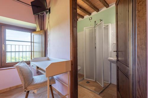 a bathroom with a white desk and a shower at Masseria del bosco Poderuccio in Chianciano Terme