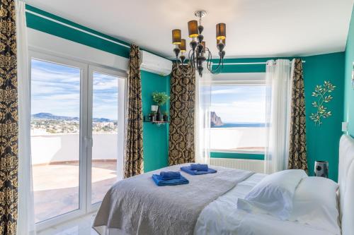 a bedroom with a bed and a large window at Villa Sol y Mar in Calpe