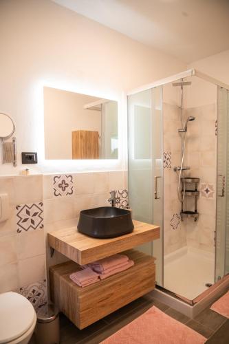 a bathroom with a sink and a shower at Alfio's Alpen Suite in Roncone